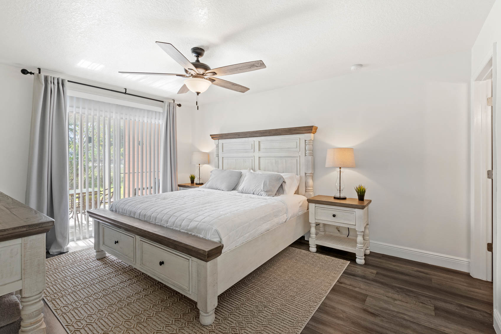 primary bedroom with bed and curtains